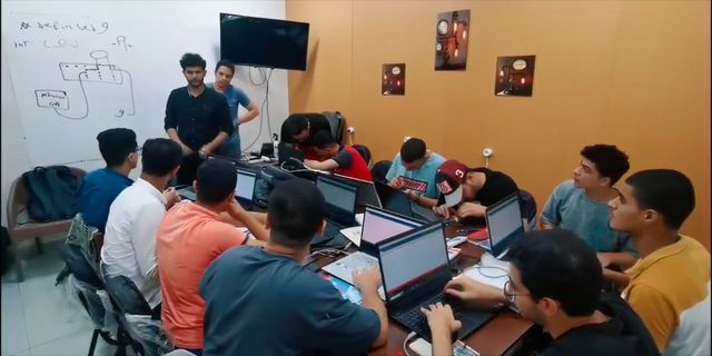 A full class at laptops and boards